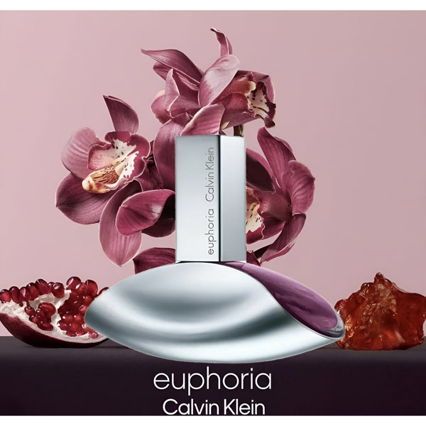 Calvin Klein Euphoria perfume bottle with flowers and pomegranate on a pink background
