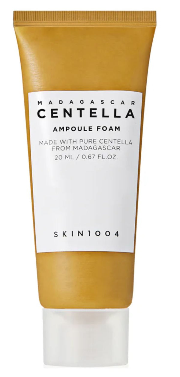 A squeeze tube of SKIN1004 Madagascar Centella Ampoule Foam, featuring a metallic gold upper and lower section with a white label in the center and a white cap at the bottom.